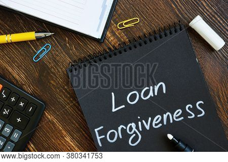 Loan Forgiveness Note On Notepad Black Page.