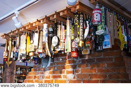 Camden, Maine, Usa - 4 August 2917: Many Beer Tops Hanging From The Ceiling Over The Bar Of The Drou
