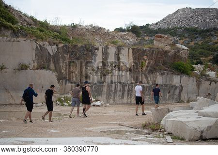 Selca, Croatia August 2020 Group Of Friends Walking Through An Abandoned Stone Quarry On The Island 