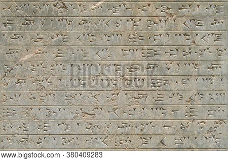 Ancient Cuneiform Font On A Stone Wall, Persepolis, Iran