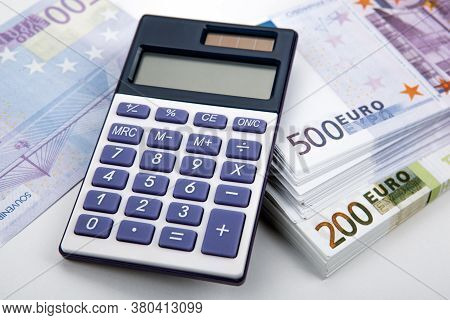 Business Still-life From A Calculator And A Bundle Of Banknotes 500 And 200 Euros Close Up