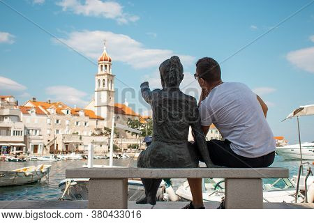 Sutivan, Croatia August 2020 Statue Of A Little Girl Pointing At The Belltower In A Small Village Of