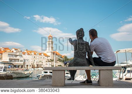 Sutivan, Croatia August 2020 Statue Of A Little Girl Pointing At The Belltower In A Small Village Of