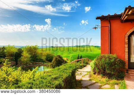 Countryhouse With A View Of The Green Hills In Tuscany, Italy. Beautiful Summer Landscape