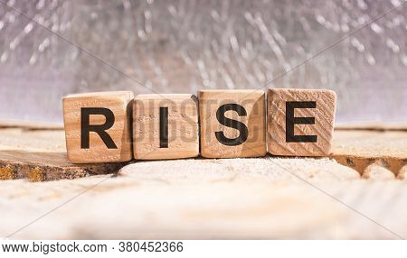 Wooden Blocks With The Word Rise. Business And Finance Concept.