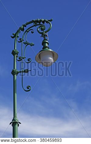 A Very Beautiful Green Lamppost With Lots Of Ornaments