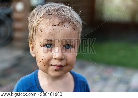 Cute Adorable Blond Caucasian Little Happy Toddler Boy Portrait With Messy Mus Spots On Face After P