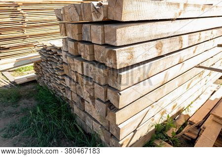 Raw Wood Beam, Stacked At Construction Site. Wood Texture, Background. Wooden Planks, Lining, Boards