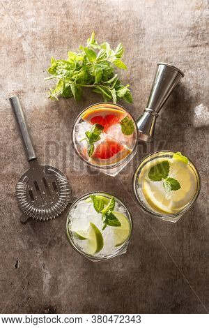 Three Colorful Gin Tonic Cocktails In Whiskey Glasses On Bar Counter In Pup Or Restaurant - Top Of V