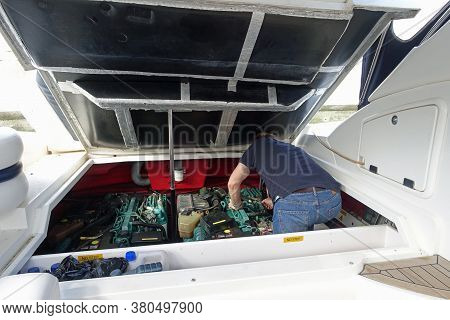 Gibraltar, 28 March 2020: Man Doing Maintenance And Trying To Fix The Engine On His Motor Boat