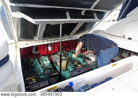 Gibraltar, 28 March 2020: Man Doing Maintenance And Trying To Fix The Engine On His Motor Boat