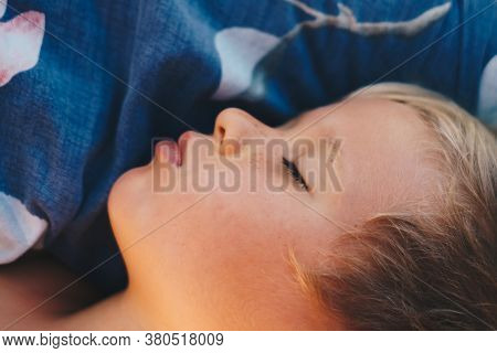 Cute Little Boy Sleep Sweetly On Pillow With Bright Morning Sunbeams From Window, Taking A Nap. Happ