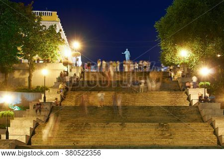 night street view of Odessa city, Ukraine, Potemkin stairs near the Primorskiy boulevard, walking people
