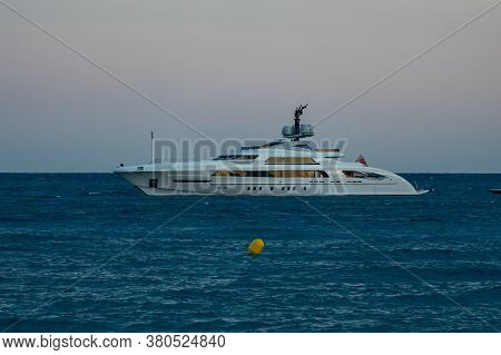 Cagnes-sur-mer, France 22.07.2020 Modern Luxury Yacht On The Sea And Flying Passenger Plane Later Ev