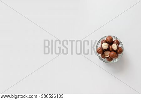 Macadamia Nuts In A Glass Bowl On Gray Background Design For Poster, Article Or Banner