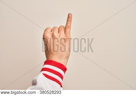 Hand of caucasian young man showing fingers over isolated white background showing little finger as pinky promise commitment, number one