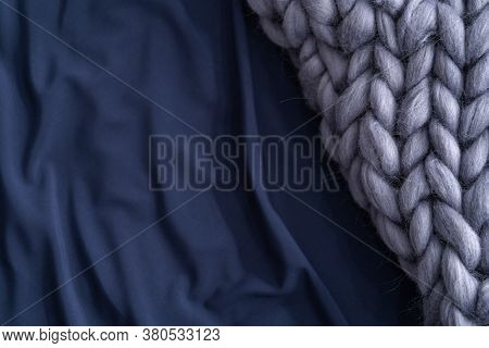 Bedding, Sheets Of Dark Blue Color, With A Gray Knitted Wool Merino Thick Blanket. A Copy Of The Spa