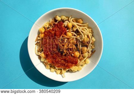 Egyptian Dish - Koshari. National Kushari In A White Plate On A Blue Background