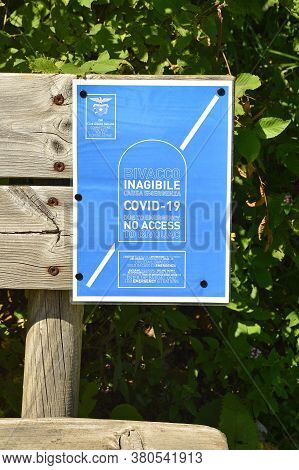 Val Alba Nature Reserve, Italy - August 9th 2020. A Sign In Both English And Italian On A Bench At T