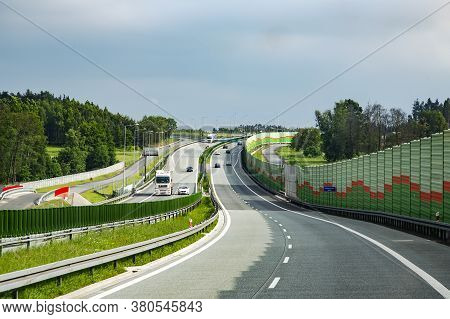 Europe, Poland, Sertember, 2014 - Long Glass Wall Next To Highway To Protect Houses Behind It From L