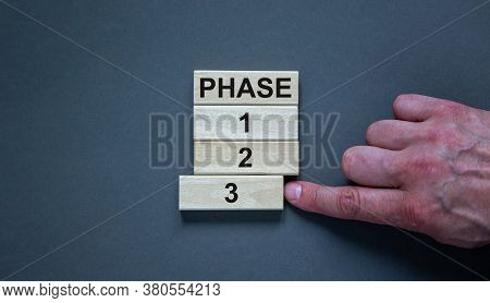 Wooden Blocks Form The Words 'phase, 1, 2, 3,' On Grey Background. Male Hand. Beautiful Background. 