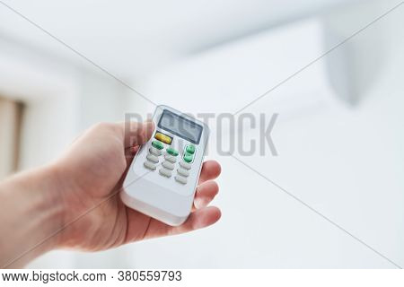 Remote Control For Air Conditioner In Hand. Room Condition Remote Control. Air Temperature Switch Fo