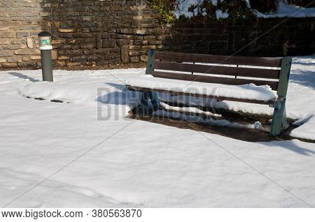 Park bench covered with snow. Sabinanigo. Huesca. Aragon. Spain.