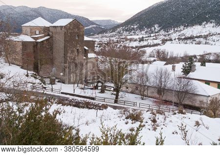 Church and rural landscape covered with snow. Sabinanigo Alto. Huesca. Aragon. Spain.