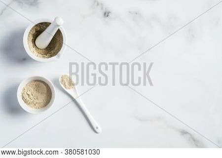 Ubtan Cosmetic Face Mask Preparation. Ubtan Powder In Bowl And Mortar On Marble Table. Ayurvedic Fac