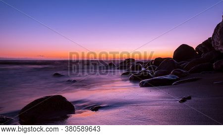 Amazingly Beautiful Winter Sea Coast At Sunset, Curved Coast Line With Forest In The Background, Bea