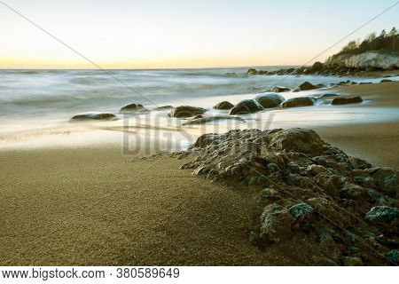 Amazingly Beautiful Winter Sea Coast At Sunset, Curved Coast Line With Forest In The Background, Bea