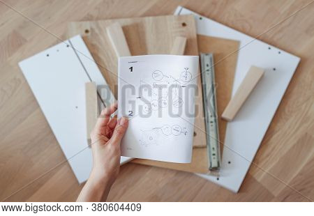 Assembling Furniture At Home. Self-assembly Of The Bedside Table. Details Of The Nightstand Laid Out