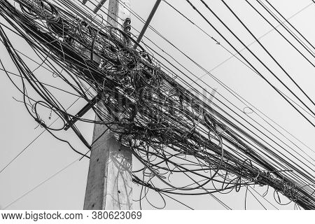 Busy High Voltage Cables With The Cable On The Electric Pole On The Sky Background, The Tangled Elec