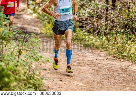 Man Athlete In Compression Sleeveless Socks Running Forest Trail Marathon