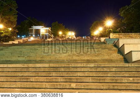 night street view of Odessa city, Ukraine, Potemkin stairs near the Primorskiy boulevard, walking people