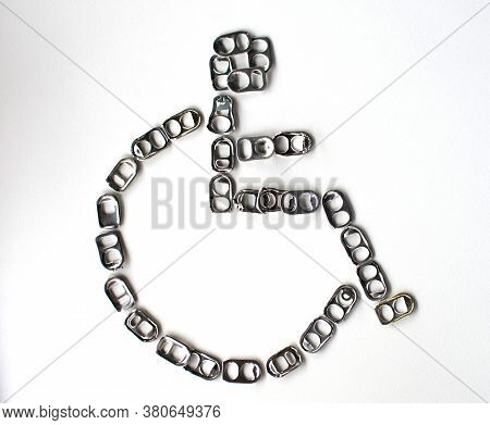 Recyclable Aluminum Lid Placed As A Disabled Symbol On A White Background Can Be Used To Make Prosth
