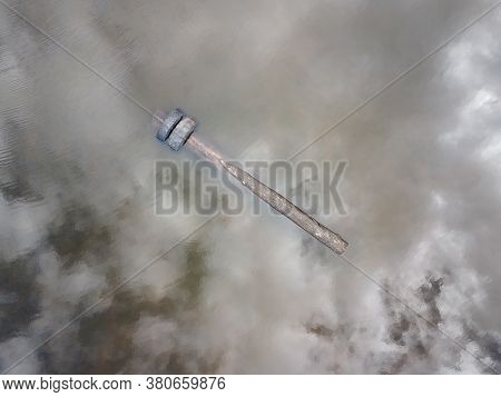 Log With Tires Floating In A Pond Top View Aerial Photo.
