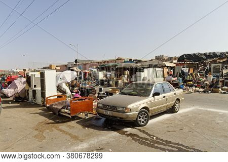 Meknes, Morocco, Feb, 7, 2019, Street Fleemarket On Sidewalk, Blue Sky With Old Covered Sales Hall. 