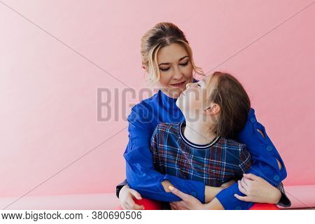 Mom And Daughter Cuddle Love Family Pink Background