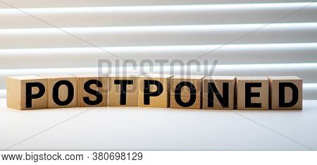 Postponed - Words From Wooden Blocks With Letters, Postponed Concept, Top View Gray Background