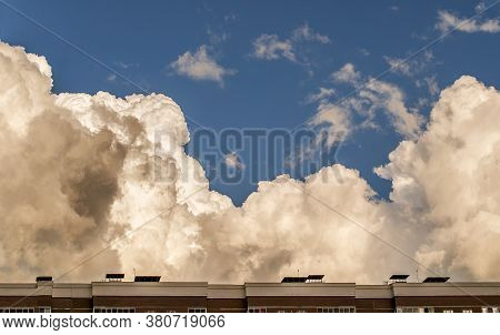 Black Thunderclouds Storm Clouds Over The City Building Before The Rain. The Weather Is Getting Wors