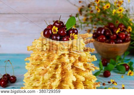 Lithuanian Spit Cake Sakotis Decorated With Fresh Cherries.