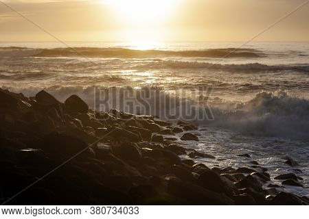 Ocean Waves Breaking On The Rocky Beach