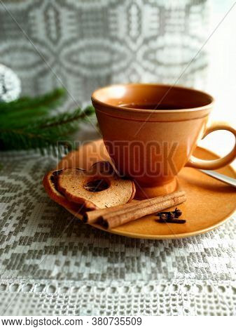 Christmas Tea On Linen Tablecloth In The Shaffron Colored Cup.