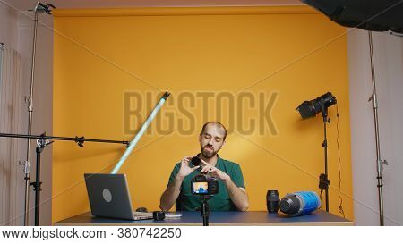 Photography Vloger Holding Round Nd Filters To The Camera While Recording Video. Variable Nd Filter 