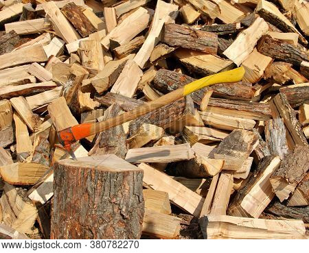 Pickaroon In A Log With A Stack Of Firewood In The Background