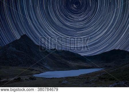Stunning Vibrant Milky Way Composite Image Over Beautiful Landscape Image Of Stream Near Llyn Ogwen 
