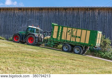 Bavaria/ Germany - August 07,2020: Fendt Favorit 926 Vario Tractor Drives With A Krone Zx400gl Trail