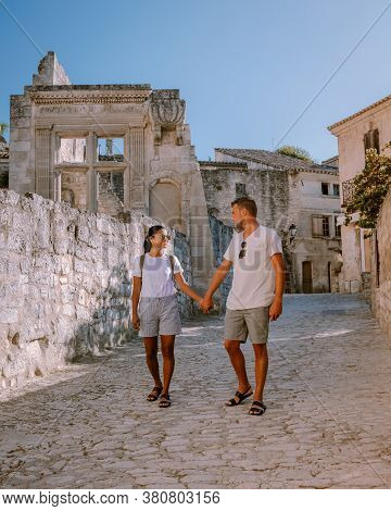 Couple Visit The Town Of Les Baux De Provence France, Old Historical Village Build On A Hill In The 