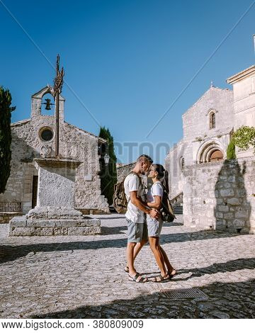 Couple Visit The Town Of Les Baux De Provence France, Old Historical Village Build On A Hill In The 